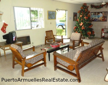 Couches, christmas tree, TV in lobby of motel